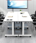 Top Shelf Flip Top Mobile Training Table And Two Chair Set With Dead Simple Folding Operation Tough Rolling Casters Smart Storage Tray And Modesty Shield For Active Rooms in a modern meeting space.