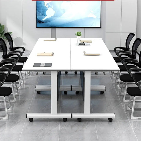 Top Shelf Flip Top Mobile Training Table And Two Chair Set With Dead Simple Folding Operation Tough Rolling Casters Smart Storage Tray And Modesty Shield For Active Rooms in a modern meeting space.