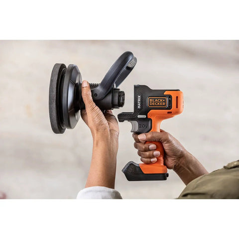 Hands holding Matrix 20V Max Buffer Kit For Cars Floors And Furniture With 3500 RPM Random Orbital Polisher, cordless, orange.