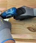 Maxiflex PIP Large Ultimate Micro Foam Nitrile Coated Work Gloves with Nylon Liner gripping a tool on wood