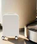 20 Inch Carry On Suitcase With Built In Cup Holder And Usb Charging Port Hardshell Travel Bag next to baggage claim area.