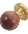 Close-up of Walnut Brass Cabinet Knobs And Vintage Drawer Pulls For Furniture Hardware With Single Hole Mount, walnut wood and brass finish.
