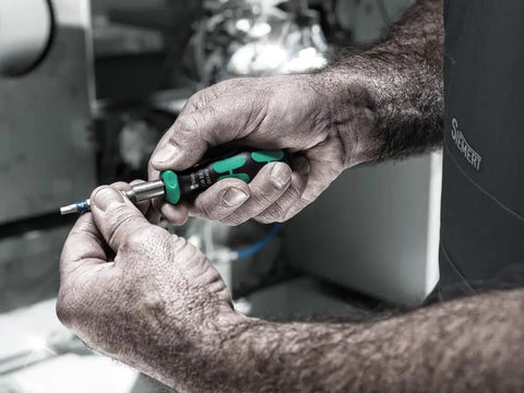 Hands using RA S Bitholding Screwdriver With Ratchet In Handle with 1/4 in hex drive on electronics