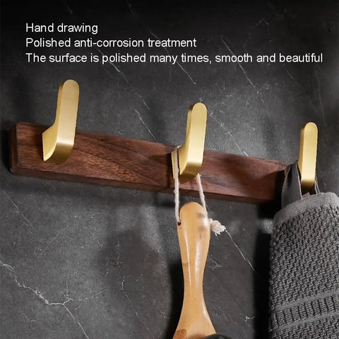 Straight Up Sturdy Five Hook Wall Coat Rack designed for hanging daily duds, hats, keys, and towels, showing polished gold hooks on wood.