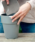 Person repairing a chipped gray pot using Epoxy Repair Putty For Quick Fixes Handy Two Part Moldable Adhesive That Bonds To Damp Surfaces