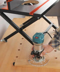 Slick Foldable Benchtop Trim Router Table With Adjustable Height Stand and Portable Workshop Station for woodworking, showing router use.