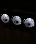 3-in-1 automotive gauge cluster with black panel; three white-face gauges: volt, temp, oil/psi.