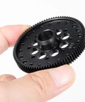Hand holding Arrma Compatible Carbon Steel CNC Machined 48P 91T Spur Gear for One Tenth Scale 4X4 Granite Senton Vortek RC Cars