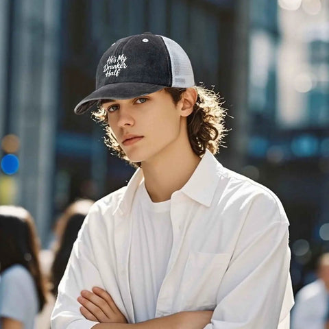 Young man wearing Men's Adjustable Outdoor Trucker Hat With Breathable Mesh, lightweight cap with text design on front.