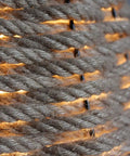 Close-up of Coastal Rope Rattan Handwoven Pendant Lamp In Natural Finish, showcasing woven texture and warm light glow.
