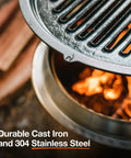 Close-up of Bonfire Grill Top And Hub Cast Iron Cooktop With Stainless Steel Hub over fire pit, showing flames and grill texture.