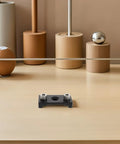 Adjustable Dowel Jig Kit With Precision Drill Guide Locator For Woodworking shown on a minimalist desk with decorative items.