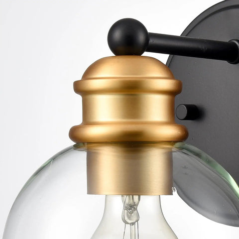 Close-up of Modern Farmhouse Black And Gold Bathroom Wall Sconces globe with wrought iron frame and handcrafted glass globes.
