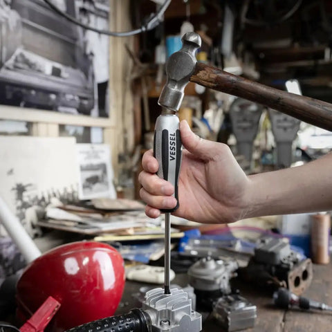 Hand holding a Vessel screwdriver in workshop, showcasing Impact Wrench 2 Piece Set Built Tough For Real World Jobs With User First Design.