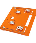 Pro Grade Aluminum Circular Saw Base Plate And Router Table Insert featuring orange surface and metal clamps for accurate cuts.