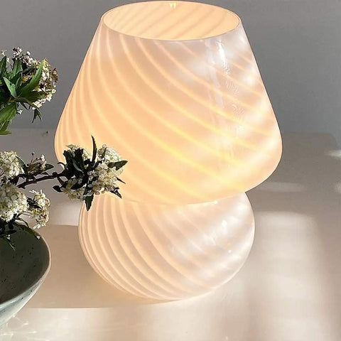 Mushroom Glass Desk Lamp With White Stripes, Vintage Murano Hand-Blown Style, lit on a table next to flowers, modern Italian design.