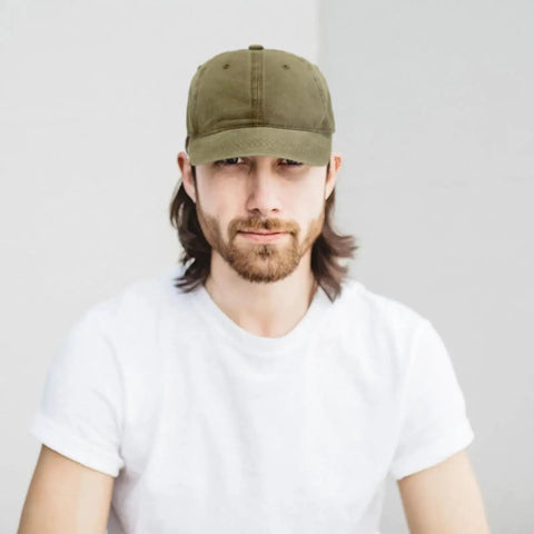 Man wearing low profile adjustable washed cotton baseball cap dad hat for men and women versatile golf style and everyday streetwear