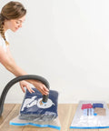 Woman using 3 Pack Vacuum Compression Storage Bags With Hand Pump For Travel Clothes Clear Large 31.5 Inches By 23.6 Inches