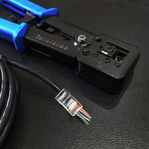 RJ45 Crimping Tool Ethernet Crimper for Cat6 Cat6a Cat5e Cat5 and RJ12 Ends Pass Through Connectors Compatible next to cable on table