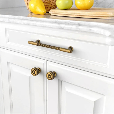 Five Inch Brushed Antique Brass Cabinet Pulls, Ten Pack, heavy duty handles on white kitchen cabinet drawer.