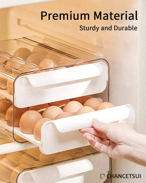 Hand pulling tray from big capacity fridge egg organizer with 2 stackable clear trays, holds up to 32 eggs, cradle design grooves.