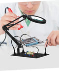 Six Piece Soldering Arm Set With Flexible Clamp Holder for welding clamps and magnifying glass lamps in use on circuit board.