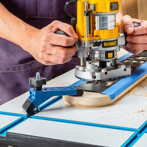 Man using CNC router with Bit Saver Hold Down Clamps For CNC Routers, Five And A Half Inch Long By One And A Quarter Inch Wide, Two Pack