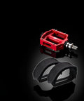 Image of Two Pack Black Beam Strap Pedal Straps for Fixed Gear Bikes and Cleats alongside a red bike pedal on a black background.