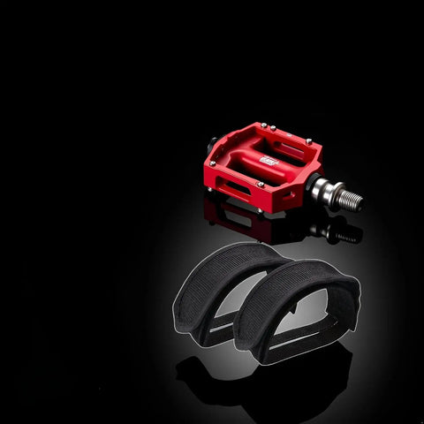 Image of Two Pack Black Beam Strap Pedal Straps for Fixed Gear Bikes and Cleats alongside a red bike pedal on a black background.