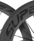 Close-up of Carbon Clincher Wheelset 700C Road Bicycle Wheels With 60 And 88mm V Shape Depth Basalt Braking Surface 3K Matte Finish