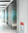 Fully Recessed Fire Extinguisher Wall Cabinet Heavy Duty Steel Safety Box mounted in a modern hall near elevators.
