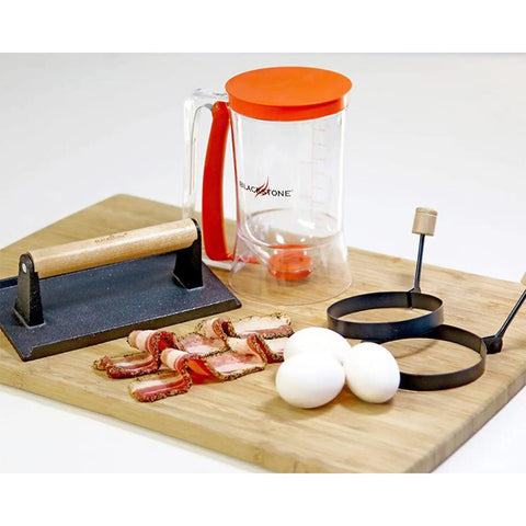 Outdoor Griddle Breakfast Prep Kit with trigger pancake batter dispenser, cast iron bacon press, and two nonstick egg rings.