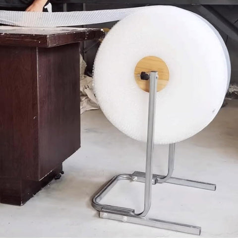 Rock Solid Vertical Bubble Wrap Roll Dispenser Heavy Duty Film Packing Station with galvanized steel base in use