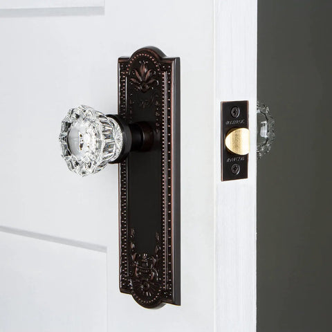 Side view of Meadows Plate and Interior Crystal Door Knob Set With Fluted Crystal Knob and Decorative Plate on a white door.