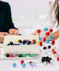 Chemistry Molecular Model Kit With 444 Pieces For Building Organic And Inorganic Structures, 3D Visual Science Learning Set displayed on a table with children assembling models.