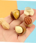 Hand holding 20 Pcs Resin Mini Food Toys Nuts Set For Dollhouse DIY Crafts, Realistic Peanut And Nut Decor for tiny kitchen.