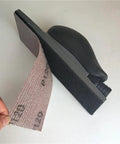 Get This Awesome 30 Pack Of 70x198mm Hook And Loop Sandpaper Sheets With 80 To 400 Grit Ranges For Orbital Sanders Made For Trimming And Drywall Work close-up of sandpaper sheet attached to holder.