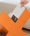 Close-up of Dope Geometric Iron Floor Bookshelf With Nordic Vibe, holding books, multi angle orange metal organizer for living room.