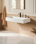 HAOCHRYSYPH Wall Mount Sink, Solid Surface, Matte White, 36 x 18 in. mounted on wall in elegantly designed bathroom.