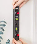 Straight Shooter Heavy Duty Dual Moving Magnet Stud Finder With Built In Nine Inch Level finds wood metal studs against a wall.