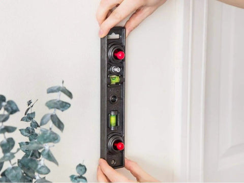 Straight Shooter Heavy Duty Dual Moving Magnet Stud Finder With Built In Nine Inch Level finds wood metal studs against a wall.