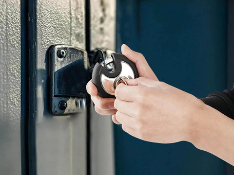 Person using Outdoor Stainless Steel Disc Padlock With Waterproof Shield And Rubber Bumper For Sheds Gates And Fences Heavy Duty Keyed Padlock