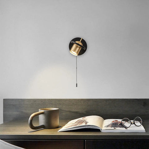 Plug In Wall Sconce Set With Chain Switch Adjustable Angle Gold Wall Lamps mounted above a desk with book and mug