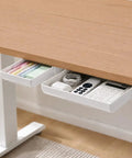 Kick Clutter To The Curb With This Slick Under Desk Drawer Organizer 2 Pack holding sticky notes, cables, and a remote under a desk.