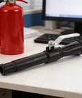 Top Shelf Fire Extinguisher Discharge Nozzle Hose With Instant Swap Spray Tip on desk, black nozzle with valve handle.
