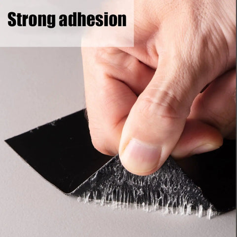 Close-up of hand peeling 4 in x 5 ft Flexible Rubberized Waterproof Tape 4 Inch 5 Foot Patch And Seal For Leaks Works Underwater Like A Boss Indoor Outdoor Use Roof Plumbing Pool And RV Repairs Black