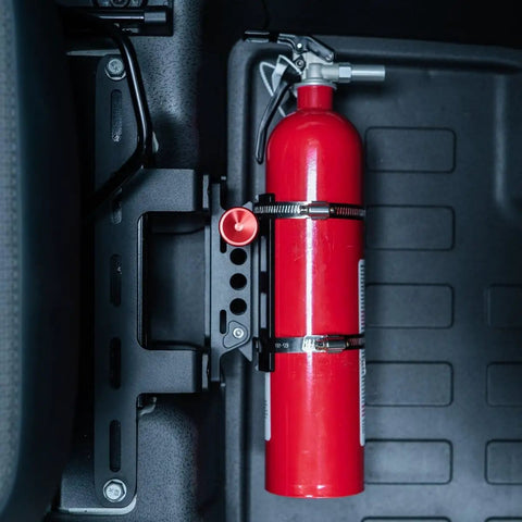 Slick Under Seat Fire Extinguisher Bracket For Ineos Grenadier Truck with secured red fire extinguisher and aluminum mount.