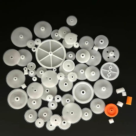 64Pcs 0.5 Module Plastic Gears Kit For DC Motors And DIY Robots shown with spindle, crown, and double gears on dark background