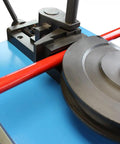 Close-up of Hardcore Programmable Electric Tube Bender With Smart Plc Auto Manual Toggle 2Hp 220Volt Motor bending red tubing.