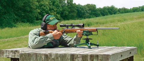 Shooter using Ambidextrous Front Rifle Rest with Adjustable Height for range time sight in, durable cast aluminum base visible